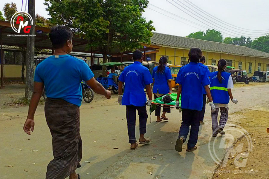 Members of the Sittwe Free Funeral Service Association carry a dead body from Sittwe Hospital in March 2023.